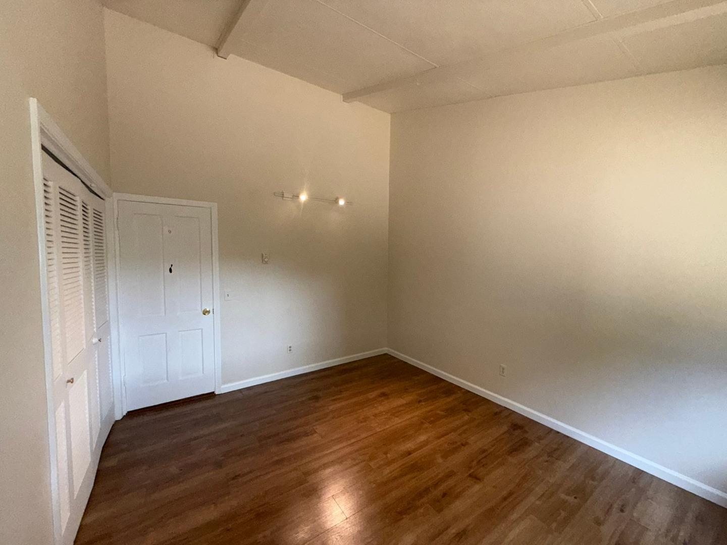 11585 McCarthy Road Carmel Valley, CA 93924 - Photo 36 of 52 a view of an empty room with wooden floor and a window