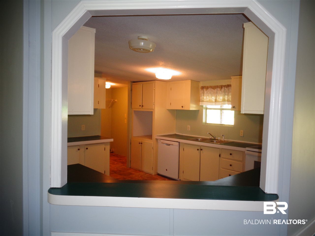 21535 A Glass And Spivey Road Robertsdale, AL 36567 - Photo 10 of 32 Pass through window to kitchen.