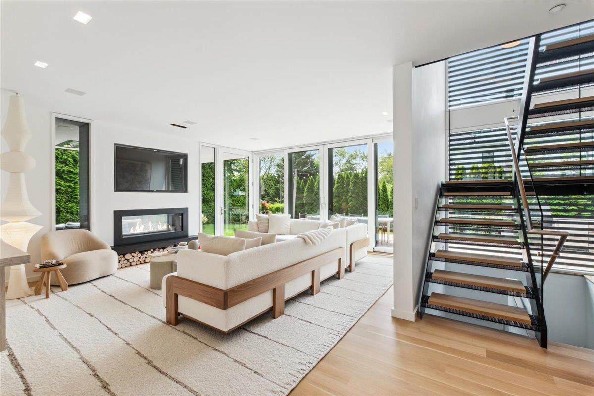 35 Halsted Place Rye, NY 10580 - Photo 3 of 41 a spacious bedroom with a balcony a bed and a fireplace
