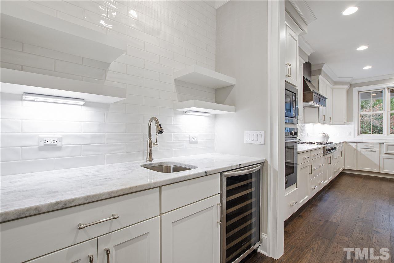 3019 Lewis Farm Road Raleigh, NC 27607 - Photo 12 of 30 a kitchen with a sink and cabinets