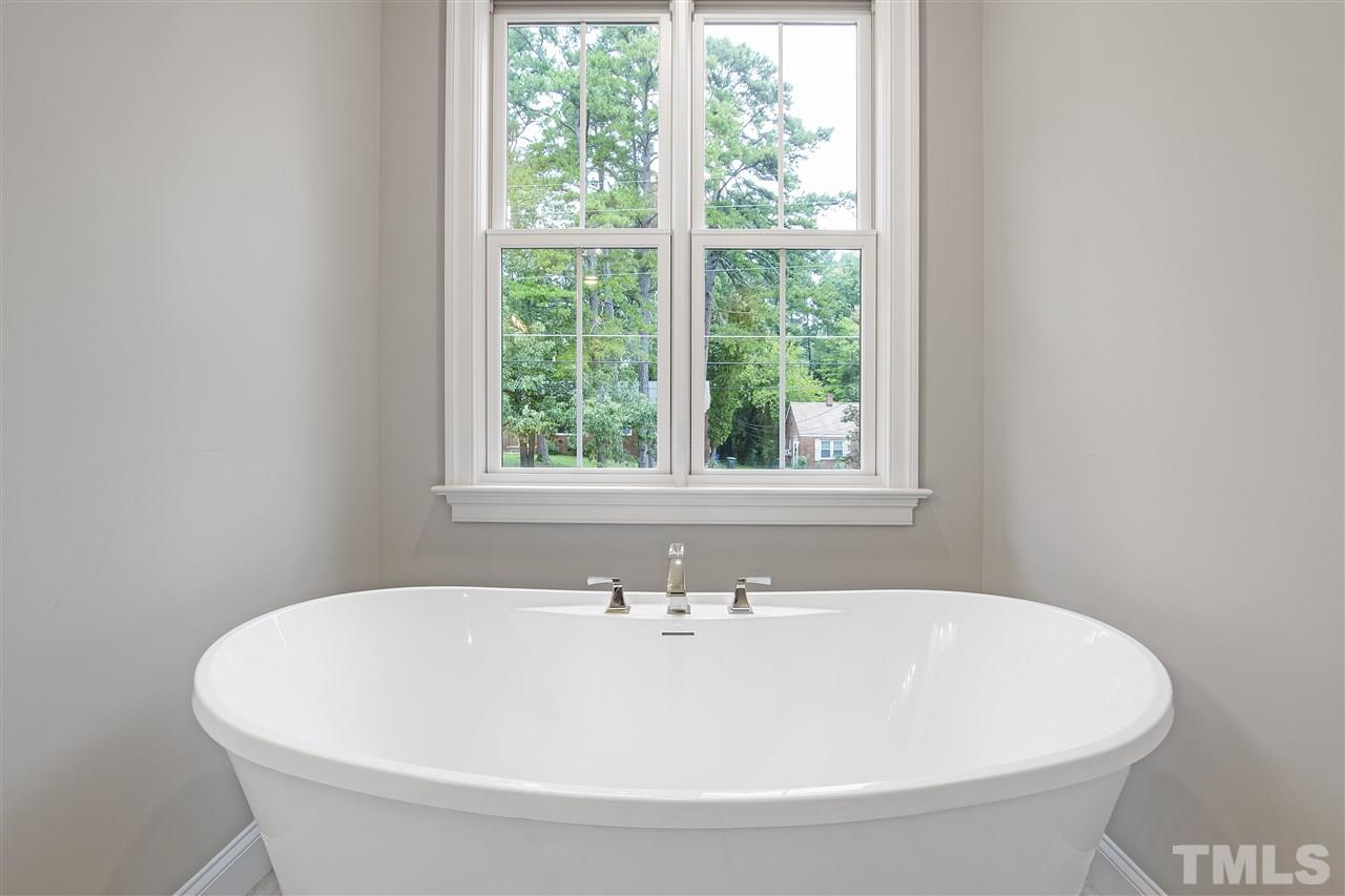 3019 Lewis Farm Road Raleigh, NC 27607 - Photo 21 of 30 a white bath tub sitting in a bathroom next to a window