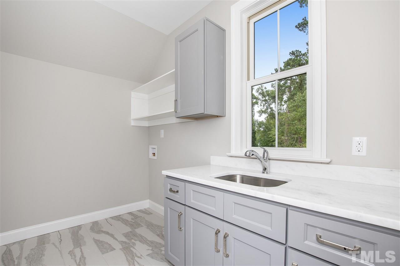 3019 Lewis Farm Road Raleigh, NC 27607 - Photo 24 of 30 a sink and a window in a room