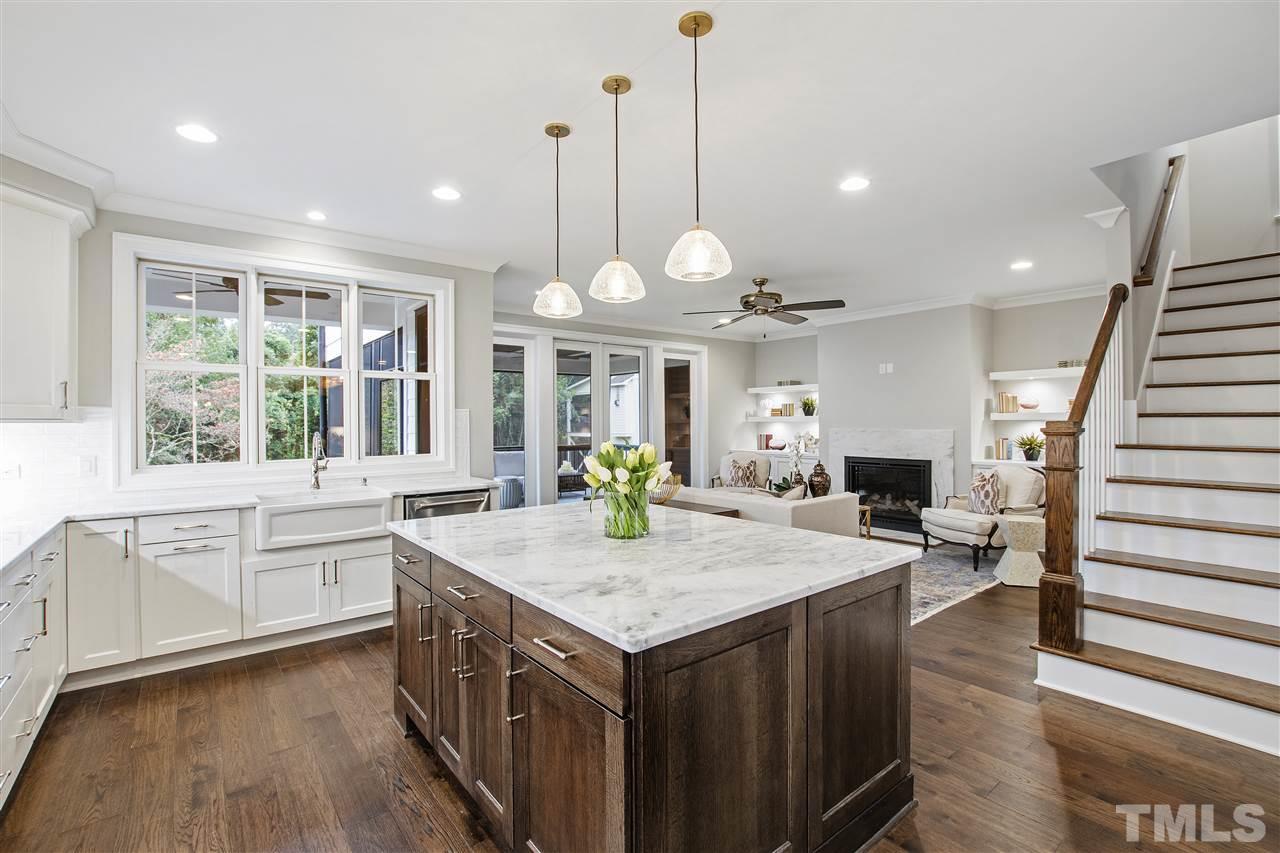 3019 Lewis Farm Road Raleigh, NC 27607 - Photo 5 of 30 a kitchen with a stove center island and wooden floors