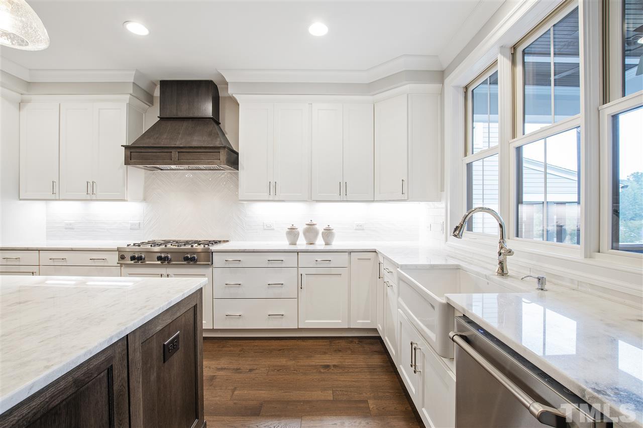 3019 Lewis Farm Road Raleigh, NC 27607 - Photo 7 of 30 a kitchen with a sink stove top oven and cabinets