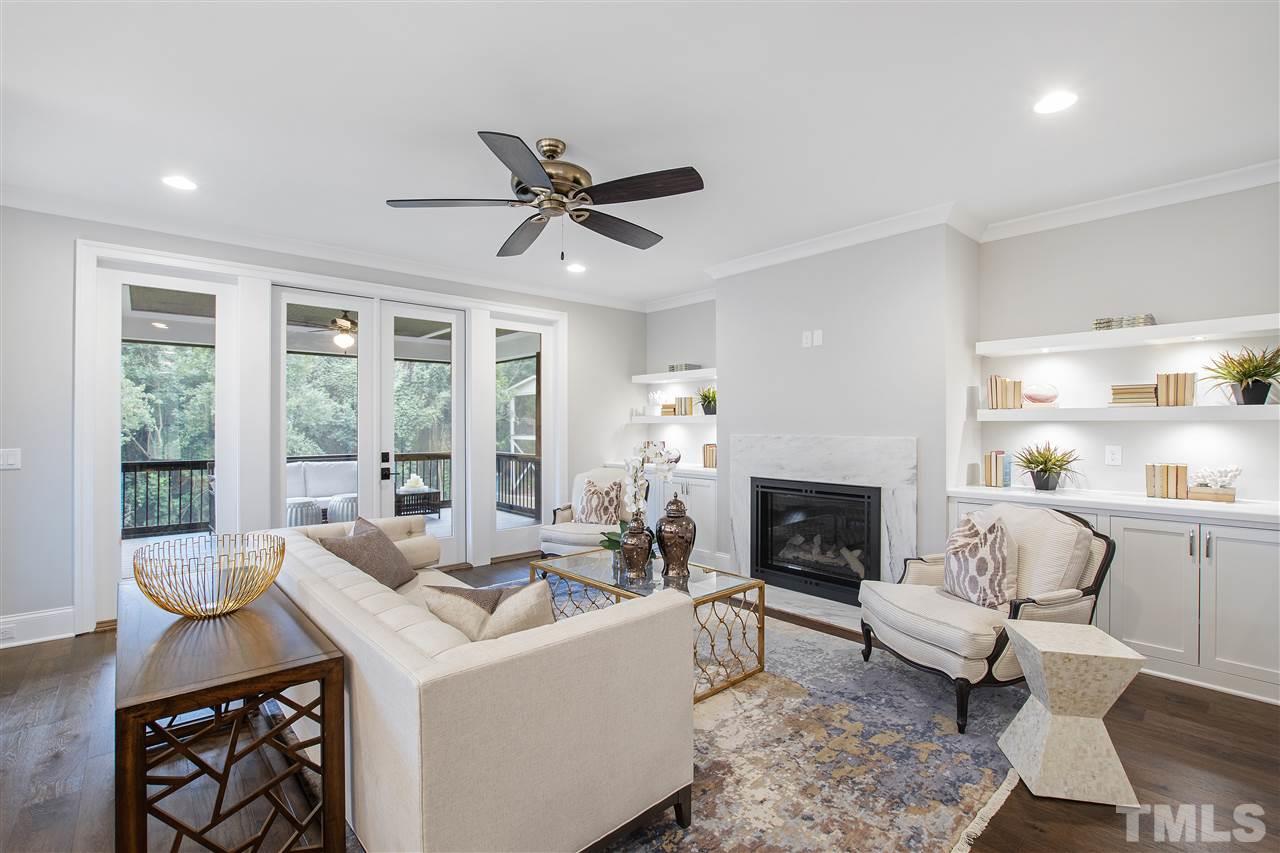 3019 Lewis Farm Road Raleigh, NC 27607 - Photo 10 of 30 a living room with furniture a fireplace and a large window