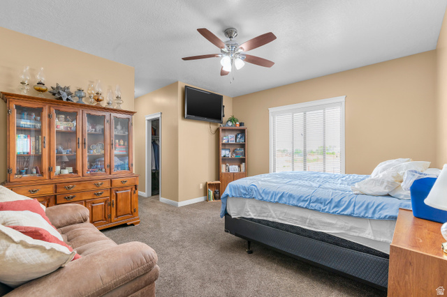 5702 950 North Ogden, UT 84404 - Photo 24 of 36 Spacious room featuring carpeting, neutral wall tones, a ceiling fan with integrated lighting, and a window with blinds