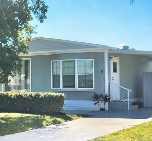 a view of a hallway with furniture and a window