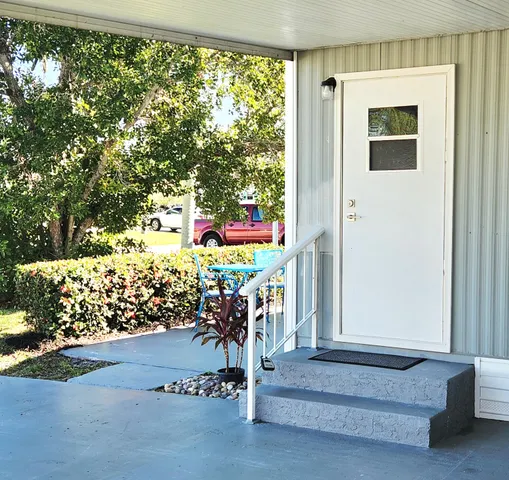 a kitchen with granite countertop white cabinets and a sink