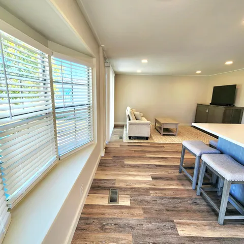 a spacious bedroom with a bed and a flat screen tv