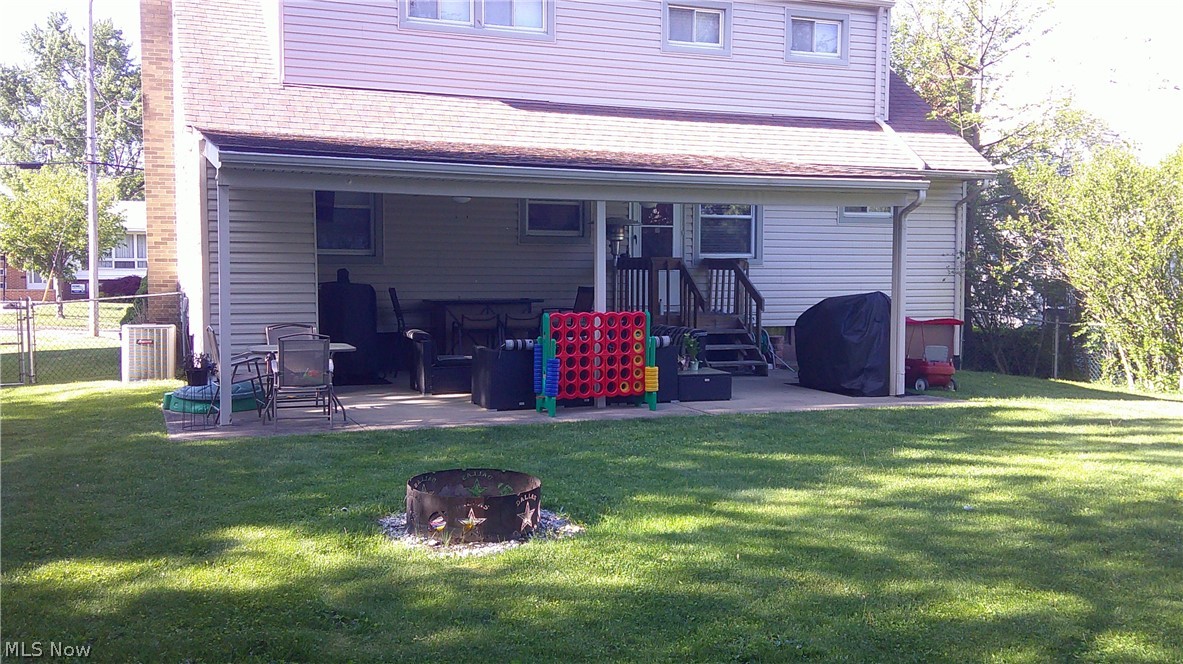 2162 Springfield Center Road Akron, OH 44312 - Photo 19 of 21 Rear view of property with an outdoor fire pit and a lawn