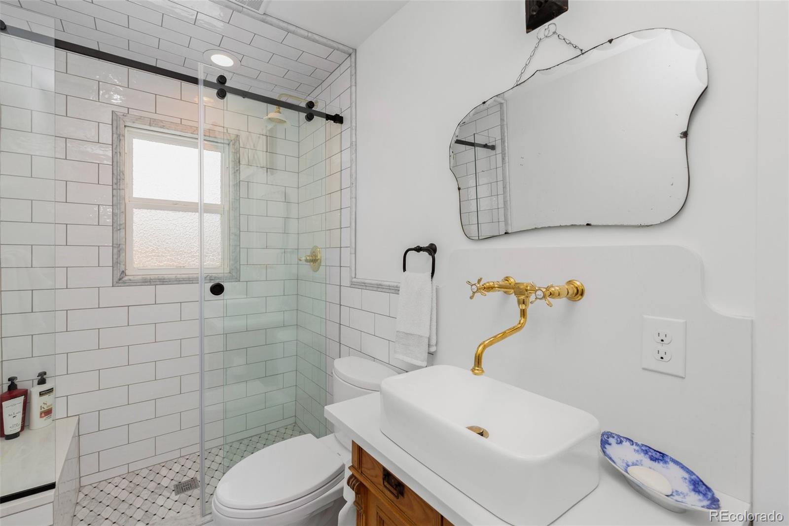 2073 South Perry Park Road Sedalia, CO 80135 - Photo 11 of 40 a bathroom with a sink toilet and shower