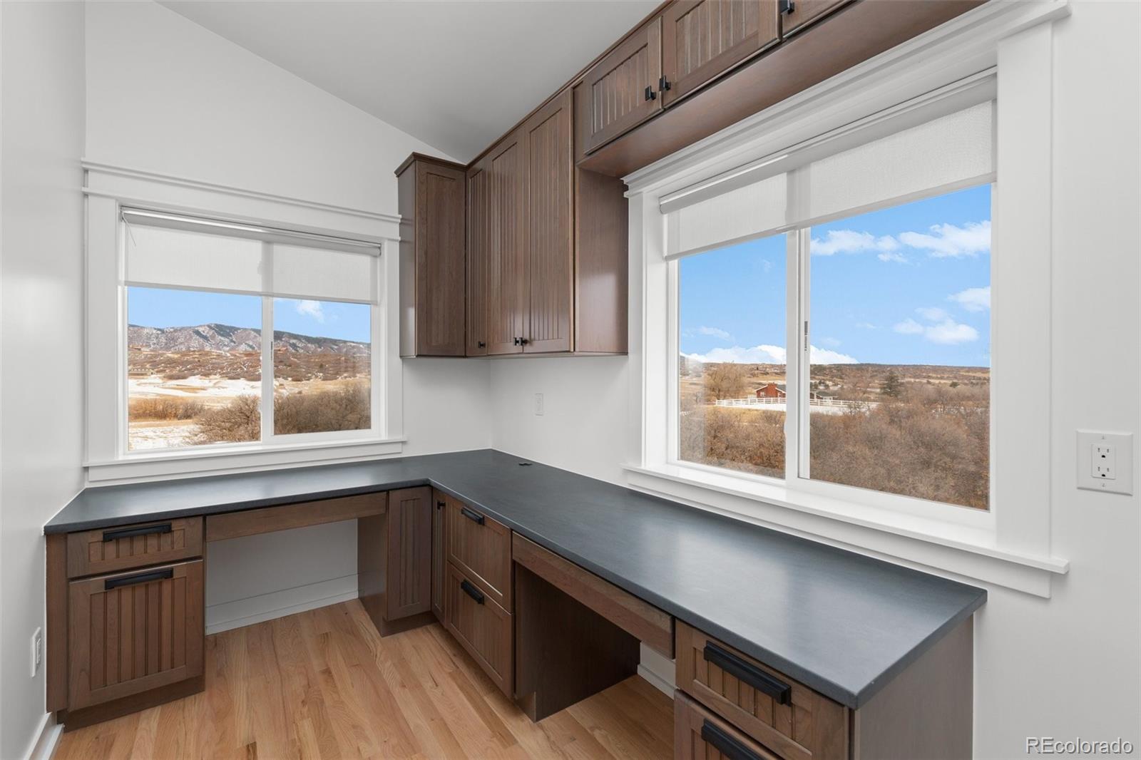 2073 South Perry Park Road Sedalia, CO 80135 - Photo 14 of 40 a kitchen with stainless steel appliances a cabinets and a large window