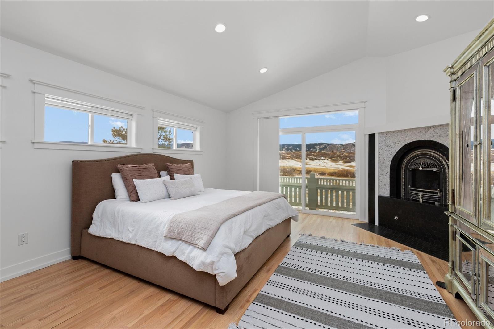 2073 South Perry Park Road Sedalia, CO 80135 - Photo 15 of 40 a bedroom with a bed and a large window