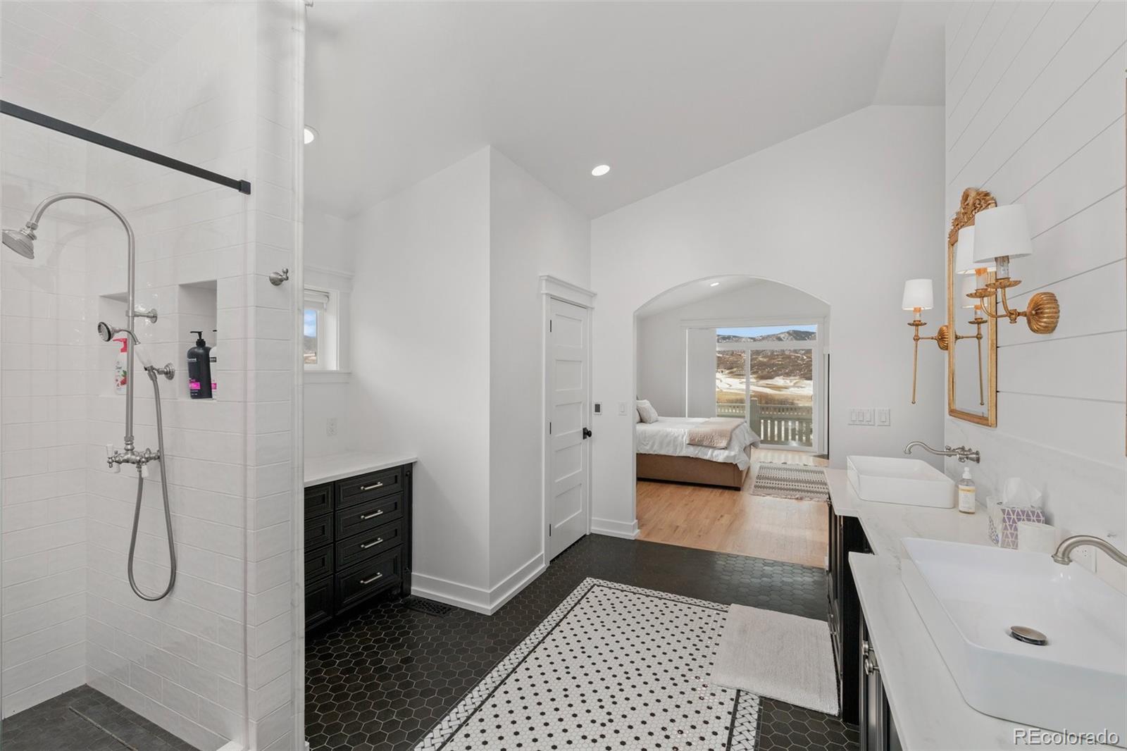 2073 South Perry Park Road Sedalia, CO 80135 - Photo 18 of 40 a spacious bathroom with a granite countertop sink mirror and shower