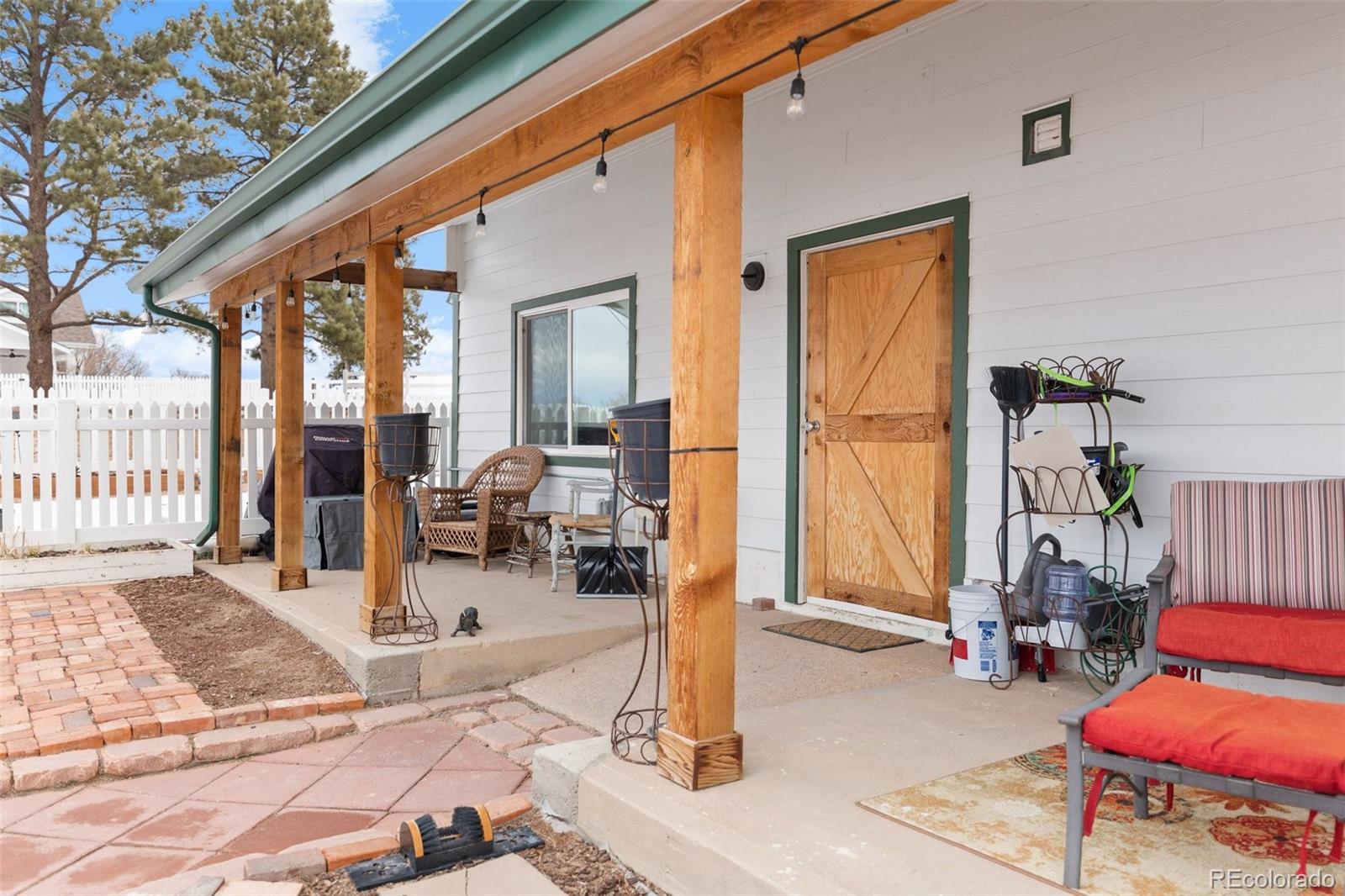 2073 South Perry Park Road Sedalia, CO 80135 - Photo 36 of 40 a living room with furniture and a floor to ceiling window