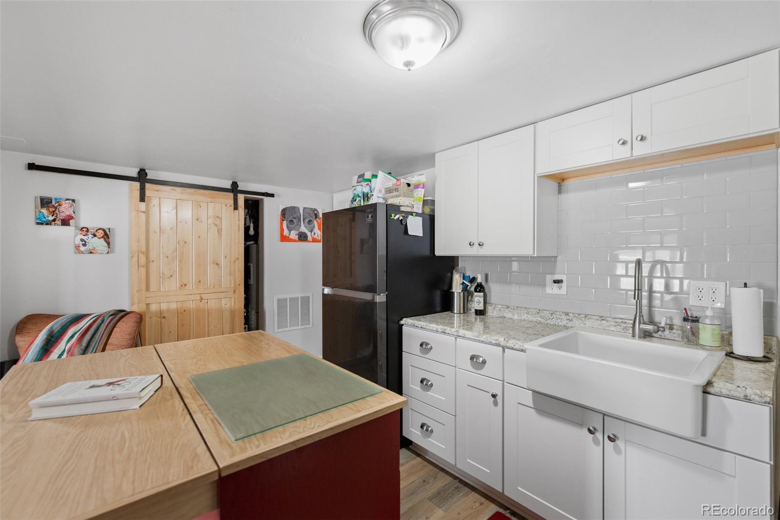 2073 South Perry Park Road Sedalia, CO 80135 - Photo 40 of 40 a kitchen that has a refrigerator and a sink