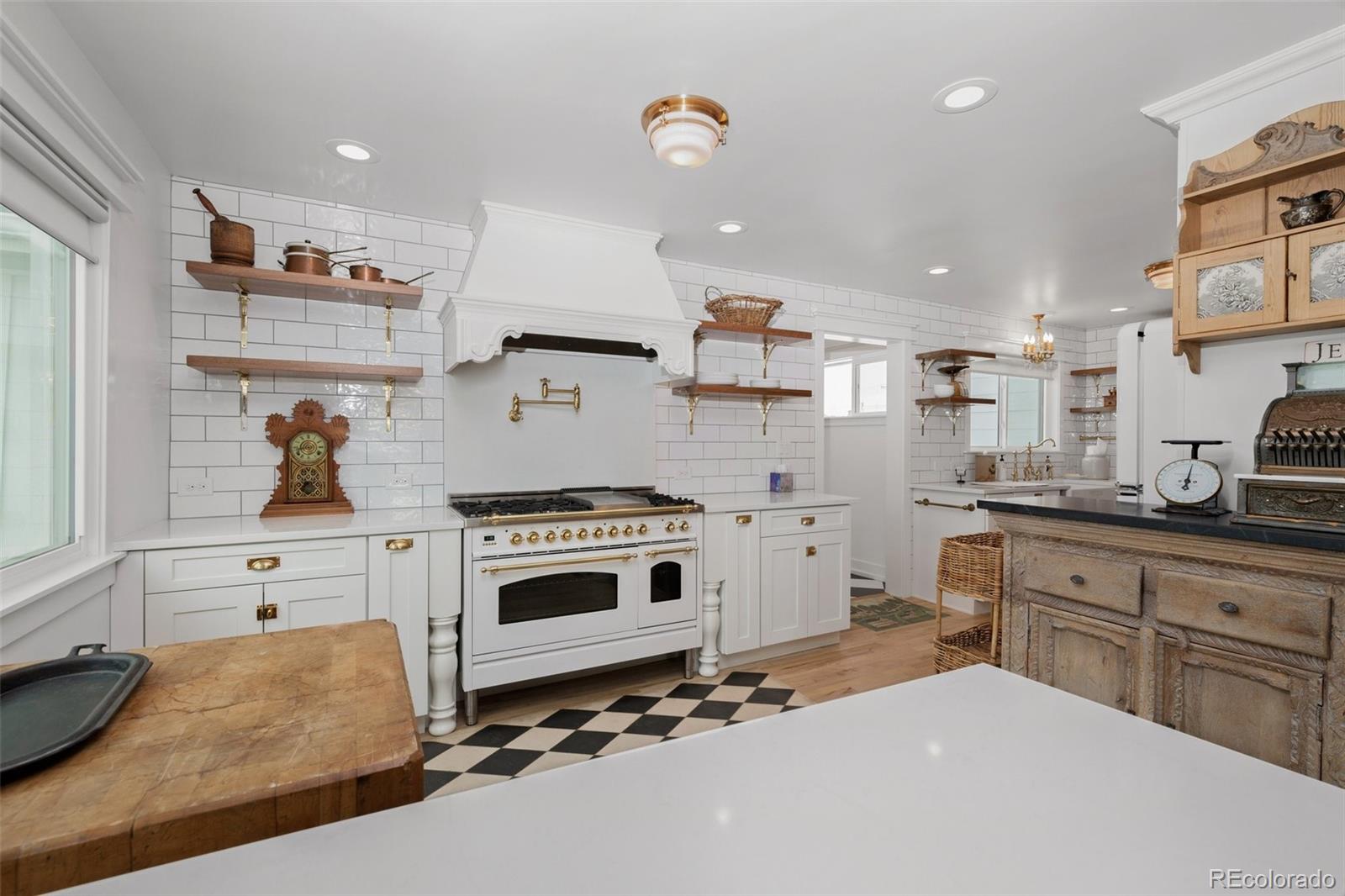 2073 South Perry Park Road Sedalia, CO 80135 - Photo 7 of 40 a kitchen with a stove a sink and a refrigerator