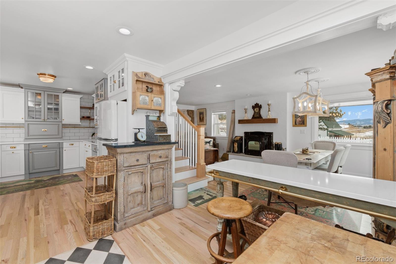 2073 South Perry Park Road Sedalia, CO 80135 - Photo 8 of 40 a room with furniture a flat screen tv and kitchen view