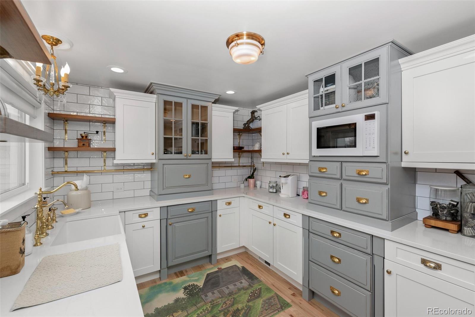 2073 South Perry Park Road Sedalia, CO 80135 - Photo 9 of 40 a kitchen with a sink a stove a microwave and cabinets