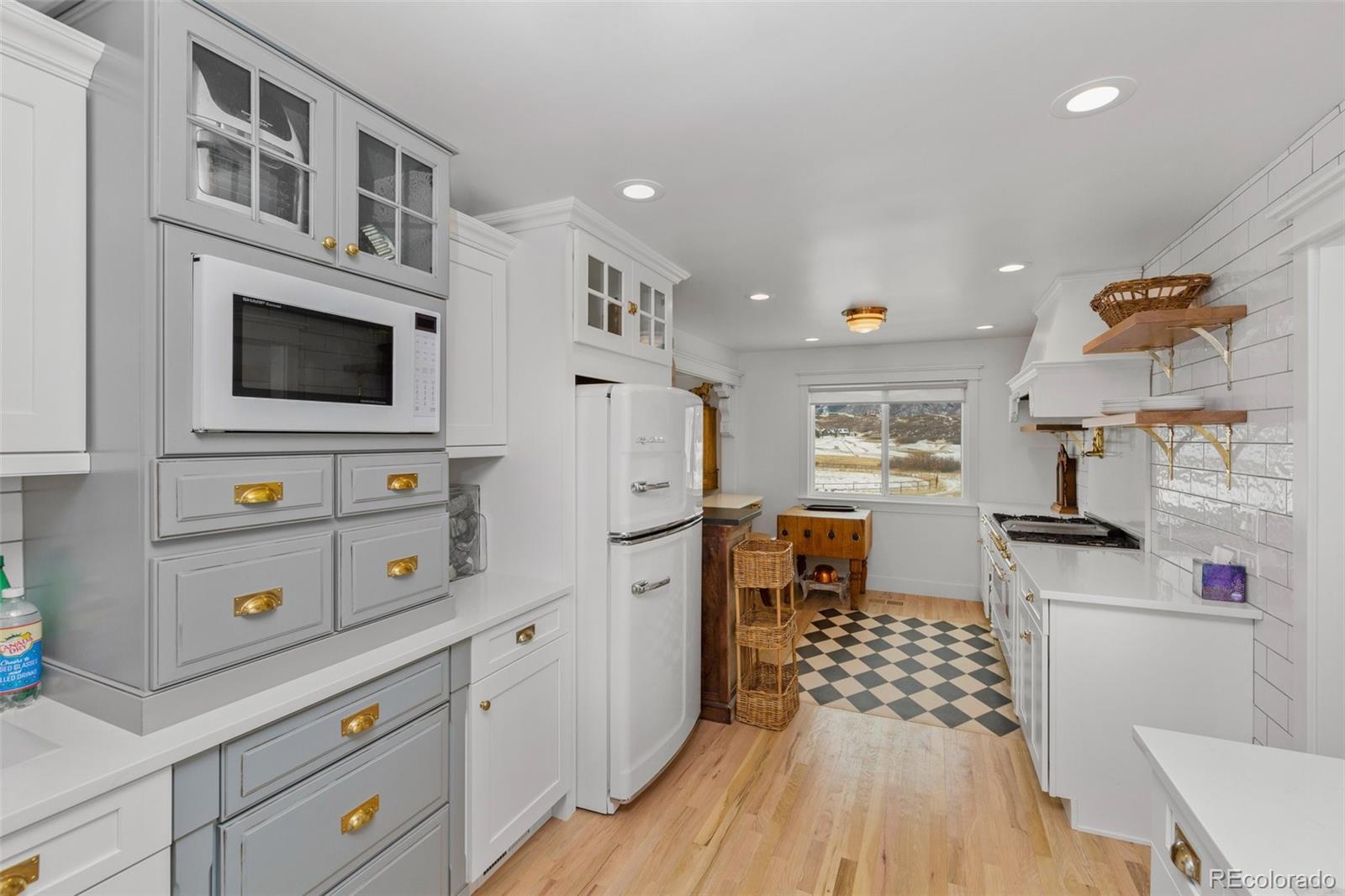 2073 South Perry Park Road Sedalia, CO 80135 - Photo 10 of 40 a kitchen with stainless steel appliances a stove a refrigerator and a fireplace
