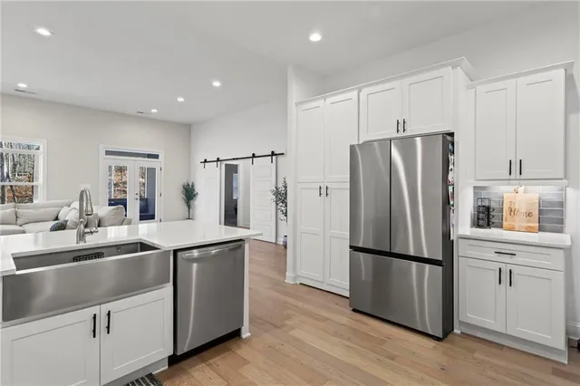 a kitchen with stainless steel appliances a refrigerator and a sink