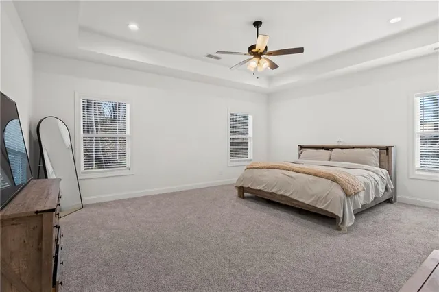a bedroom with a bed chairs and window