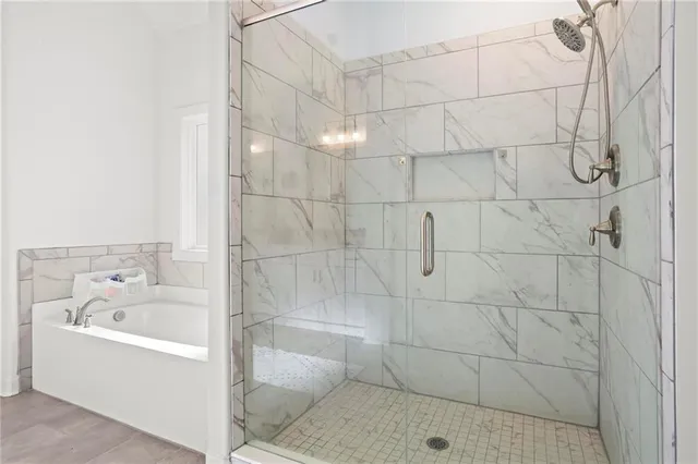 a bathroom with a bathtub and shower