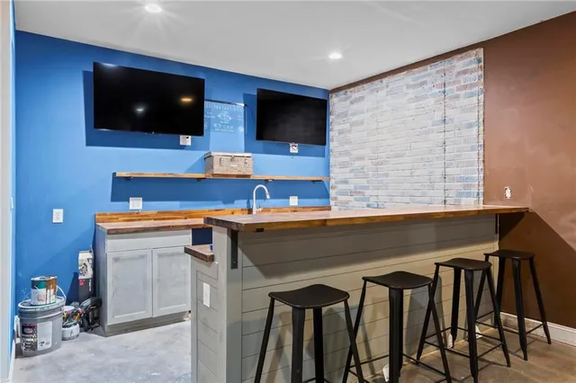 a living room with a flat screen tv and furniture