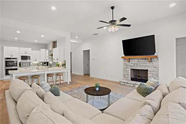 a living room with furniture a fireplace and a flat screen tv