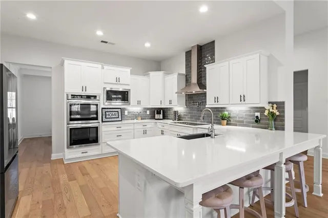 a kitchen with stainless steel appliances a stove sink microwave and cabinets