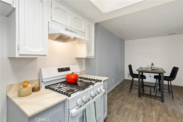 a kitchen with a stove and white cabinets