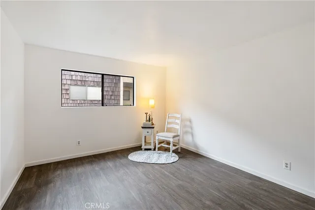 a view of a livingroom with wooden floor and a window