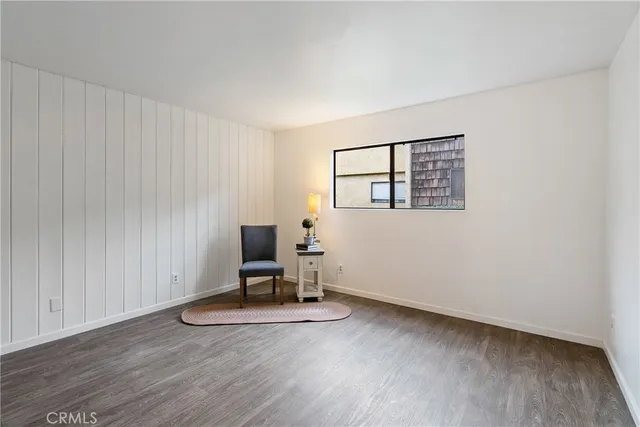 a view of a workspace with wooden floor and a window