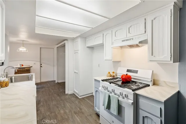 a kitchen with stainless steel appliances cabinets and a table