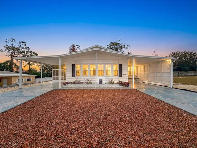 a view of a house with a backyard