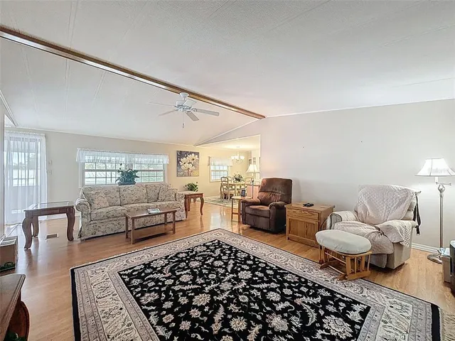 a bedroom with furniture and wooden floor