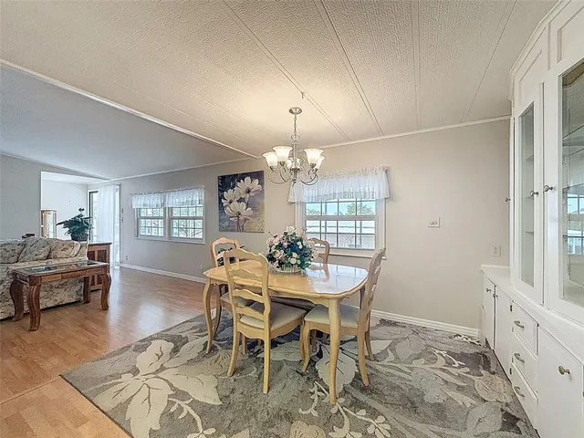 a view of a dining room with furniture and window