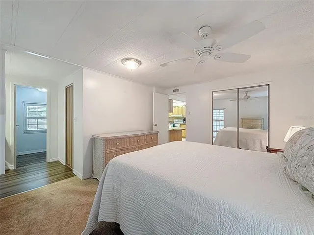 a spacious bedroom with a bed and a window