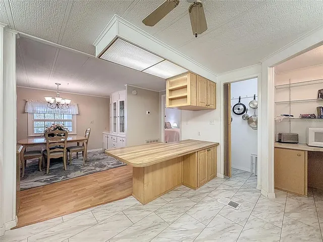 a kitchen with stainless steel appliances a stove a sink and white cabinets
