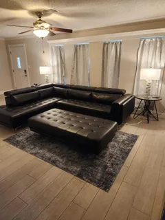 a living room with a couch and a rug
