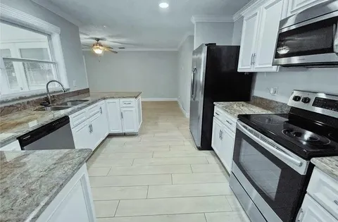 a kitchen with a sink stove and microwave