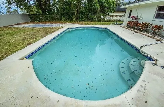 a view of a swimming pool with a porch
