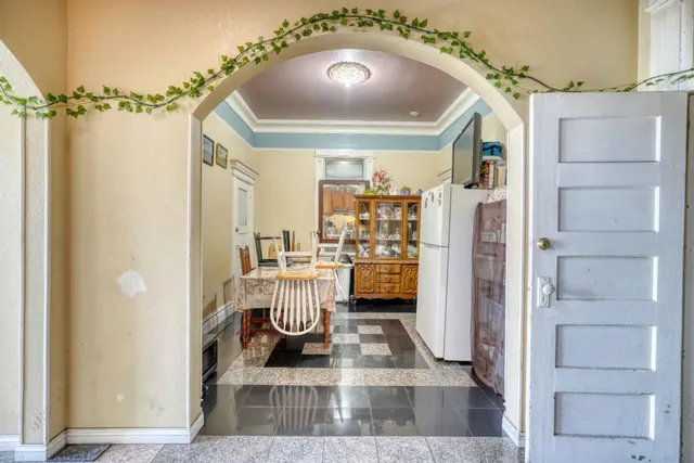 a view of a living room with furniture and a mirror