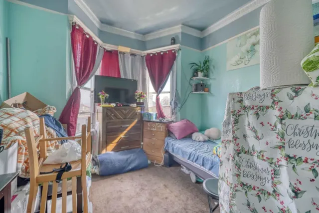 a bedroom with furniture and a wooden floor