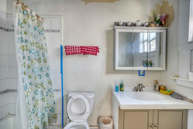 a view of a deck with wooden chairs and a potted plant