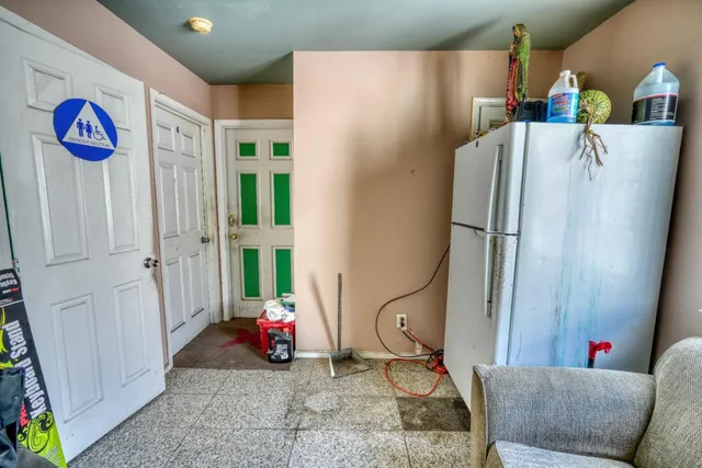 a view of a patio with fire pit and chairs