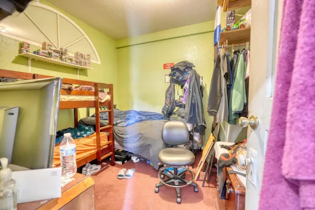 a kitchen filled with a white cabinets and wooden floor