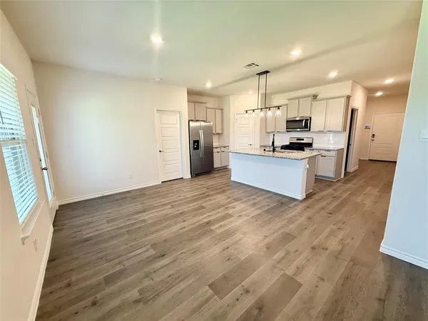 a large kitchen with kitchen island a sink dishwasher stove and refrigerator