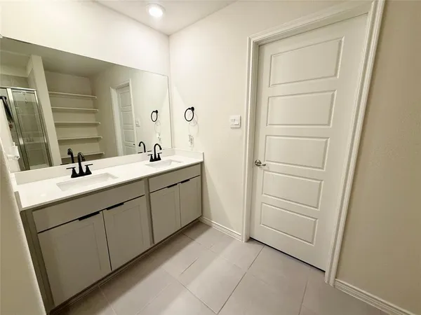 a bathroom with a double vanity sink and mirror