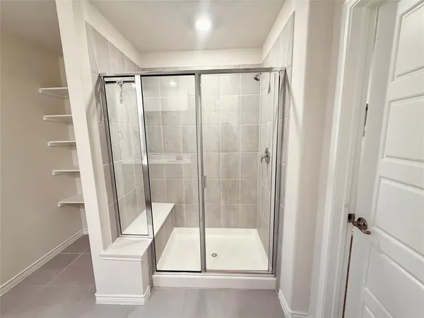 a bathroom with a shower and toilet
